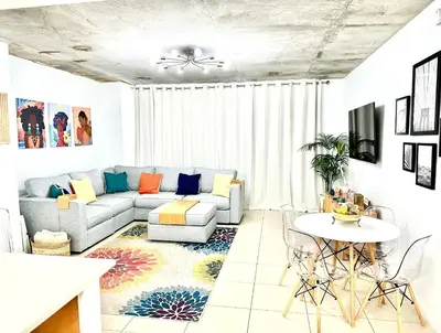 a living room with a couch and a table at Beautiful 1BD 1BTH at Midblock FREE PARKING in Miami