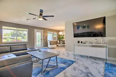 a living room with a couch and a table at Wilton Manors Home with Pool about 4 Mi to Beach! in Fort Lauderdale