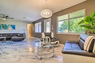 a living room with couches and a glass table at Wilton Manors Home with Pool about 4 Mi to Beach! in Fort Lauderdale