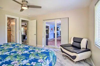a bedroom with a bed and a chair at Wilton Manors Home with Pool about 4 Mi to Beach! in Fort Lauderdale