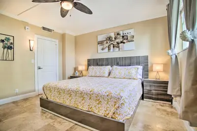 a bedroom with a bed and a ceiling fan at Ocean-View Balcony Beachfront Hollywood Apt! in Hollywood