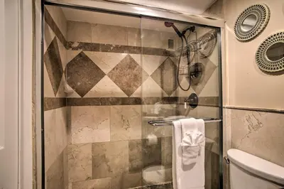 a shower with a glass door in a bathroom at Ocean-View Balcony Beachfront Hollywood Apt! in Hollywood