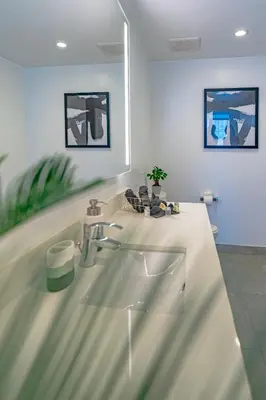 a white bathroom with a sink and a mirror at Luxurious 2-Bed Apartment with Breathtaking Bay views!! in Miami