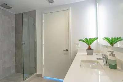 a bathroom with a glass shower and a sink at Luxurious 2-Bed Apartment with Breathtaking Bay views!! in Miami