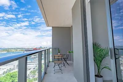 a balcony with a table and chairs on a building at Luxurious 2-Bed Apartment with Breathtaking Bay views!! in Miami