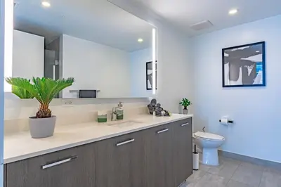 a bathroom with a sink and a toilet and a mirror at Luxurious 2-Bed Apartment with Breathtaking Bay views!! in Miami