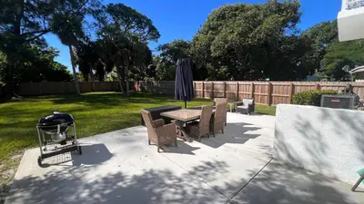 a patio with a table and chairs and an umbrella at Luxe Fort Lauderdale in Fort Lauderdale