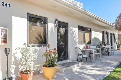 a house with a patio with a table and chairs at Walnut By The Sea in Hollywood