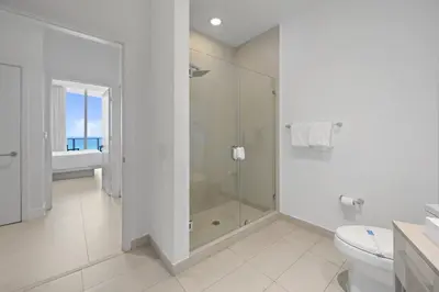 a white bathroom with a shower and a toilet at Beautiful Beachfront Penthouse in Hollywood