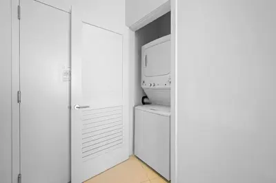 a white laundry room with a washer and dryer at Beautiful Beachfront Penthouse in Hollywood