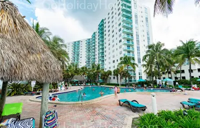 a resort swimming pool with a large building in the background at The Tides apartment Go Holiday Home 5th floor in Hollywood
