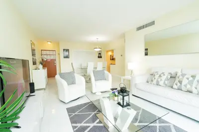 a living room with a white couch and chairs at The Tides apartment Go Holiday Home 5th floor in Hollywood