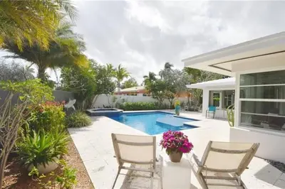 a patio with two chairs and a swimming pool at *Victoria Park Pool Home- close to beach/Las Olas* in Fort Lauderdale
