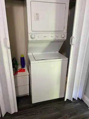 a small white refrigerator in a small room at “La Casita” Beautiful home in the heart of Miami ! in Miami