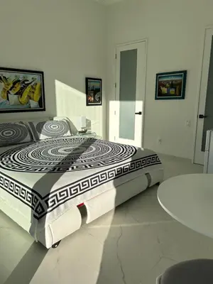 a large bed in a room with a table at Men only clothing option guesthouse near Wilton Manors in Fort Lauderdale