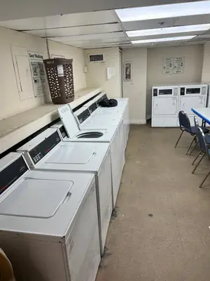 a room with white counters and chairs and a table at Lovely beaches ocean & city view in Miami Beach