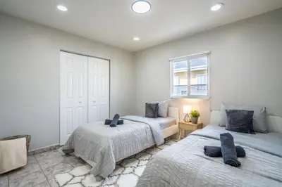 a bedroom with two beds and a window at Renovated 2 BD Home w/ Private Parking, Gallery & W/D in Miami