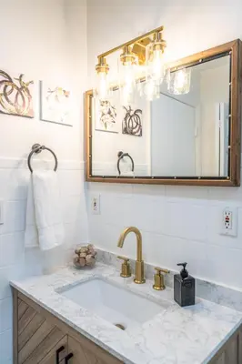 a bathroom with a sink and a mirror at Renovated 2 BD Home w/ Private Parking, Gallery & W/D in Miami