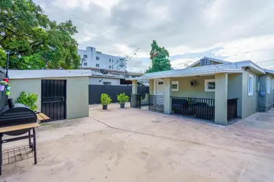 a house with a driveway in front of it at Renovated 2 BD Home w/ Private Parking, Gallery & W/D in Miami