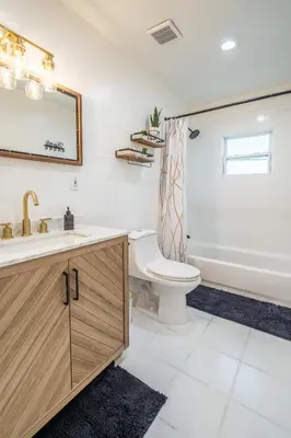 a bathroom with a sink and a toilet and a tub at Renovated 2 BD Home w/ Private Parking, Gallery & W/D in Miami