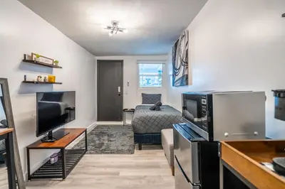 a living room with a television and a couch at Cozy Studio w/gated parking in Miami