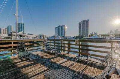 a dock with benches and a view of a city at Spacious 3 Bedroom Condo in Aventura in Aventura