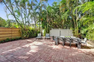 a patio with a table and chairs and a fence at By Hard Rock Guitar Hotel casino 7 min walk in Dania Beach