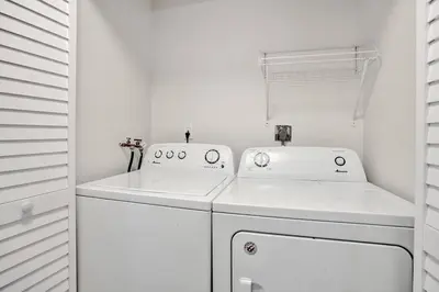 a white laundry room with a washer and dryer at By Hard Rock Guitar Hotel casino 7 min walk in Dania Beach