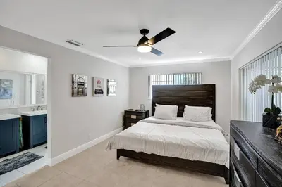 a bedroom with a bed and a ceiling fan at By Hard Rock Guitar Hotel casino 7 min walk in Dania Beach