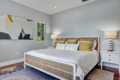 a bedroom with a large bed and a window at Victoria Park Overlook in Fort Lauderdale