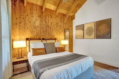 a bedroom with a large bed and two lamps at Family villa w heated pool gameroom fire pit in Davie