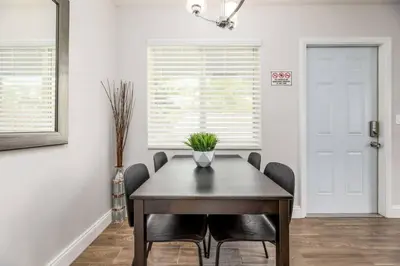 a dining room with a wooden table and chairs at The Guesthouse 1 - Wilton Manors in Fort Lauderdale