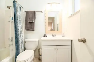 a bathroom with a toilet and a sink and a mirror at The Retreat 3 - Wilton Manors in Fort Lauderdale