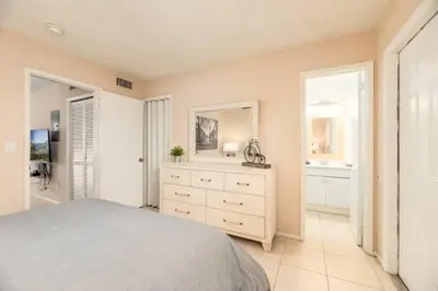 a bedroom with a bed and a dresser and a mirror at The Retreat 3 - Wilton Manors in Fort Lauderdale