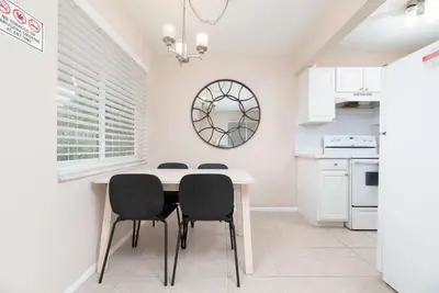 a white kitchen with a table and chairs at The Retreat 1 - Wilton Manors in Fort Lauderdale