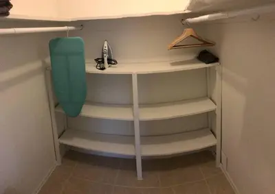 a closet with shelves and a green chair in it at The Retreat 1 - Wilton Manors in Fort Lauderdale