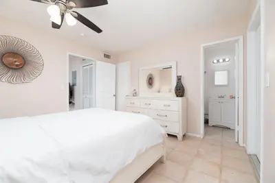 a white bedroom with a white bed and a dresser at The Retreat 1 - Wilton Manors in Fort Lauderdale