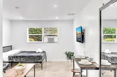 a living room with two beds and a table at Hollywood Beach Boutique Vacation Studio LB4 in Hollywood