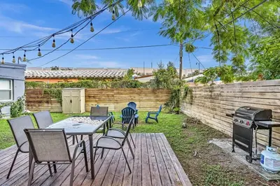 a backyard with a table and chairs and a grill at Hollywood 2 Bdrm Beach Vacation & Hard Rock Sc02 in Hollywood