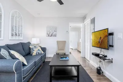 a living room with a blue couch and a table at The Guesthouse 3 - Wilton Manors in Fort Lauderdale