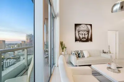 a living room with a couch and a balcony at Beautiful One Bedroom Condo 16ft ceilings at the W in Miami
