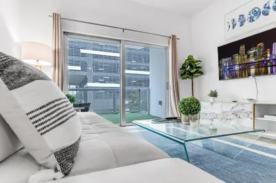 a living room with a couch and a glass table at Lovely Unit Mins from Wynwood with Free Parking in Miami