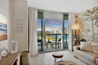a living room with a couch and a view of the ocean at Modern Resort - Balcony - Gym - Amazing Pool in Hallandale Beach
