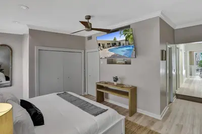 a bedroom with a bed and a ceiling fan at Brand New! Heated Pool, Golf Cart, Next to Beach in Fort Lauderdale