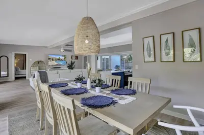 a dining room and living room with a table and chairs at Brand New! Heated Pool, Golf Cart, Next to Beach in Fort Lauderdale