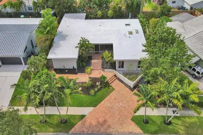 an aerial view of a house with palm trees at Brand New! Heated Pool, Golf Cart, Next to Beach in Fort Lauderdale