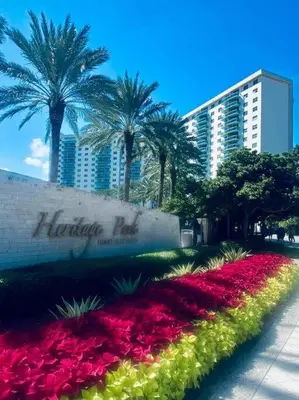 a flower garden in front of a hotel with palm trees at Ocean Reserve Piso 9 - STR 2412 in Miami Beach