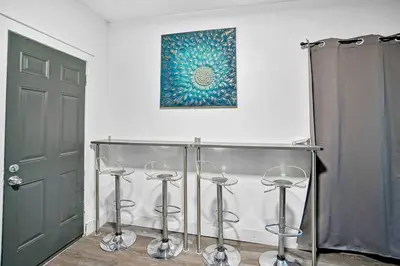 a room with four stools and a painting on the wall at River House 4BR, Pool/Hot Tub in Miami