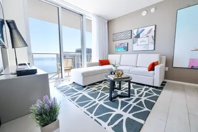 a living room with a white couch and a table at Diamond In The Sky in Hollywood