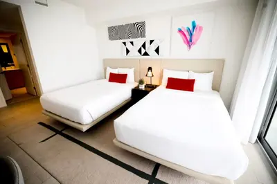 two beds in a room with white and red pillows at Diamond In The Sky in Hollywood